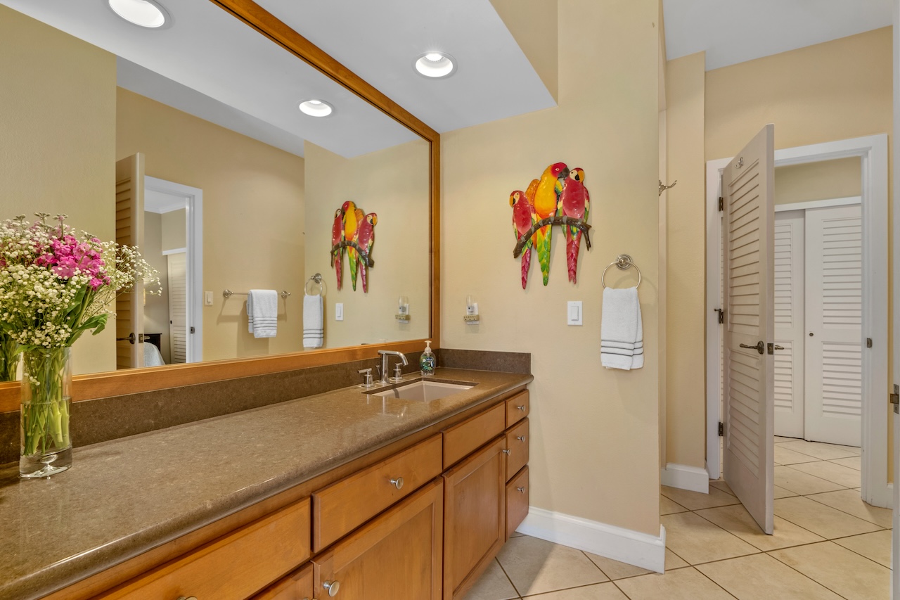 1565 Pe'e Road, Unit 211 Koloa, HI 96756 - Photo 20 of 30 a bathroom with a sink and a mirror