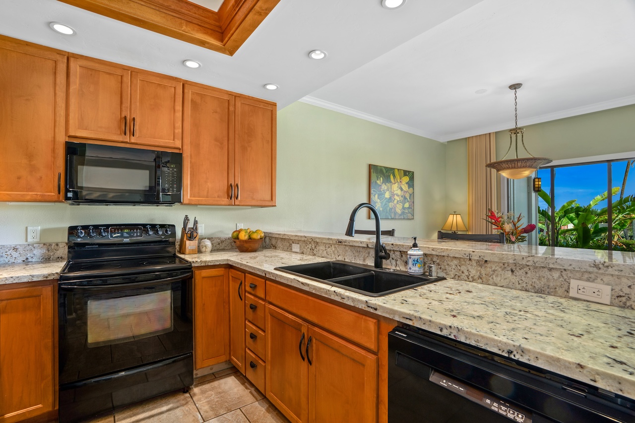1565 Pe'e Road, Unit 211 Koloa, HI 96756 - Photo 6 of 30 a kitchen with granite countertop a sink stainless steel appliances and cabinets