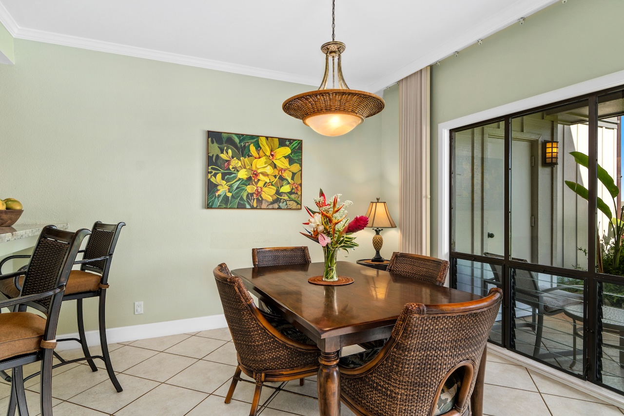 1565 Pe'e Road, Unit 211 Koloa, HI 96756 - Photo 10 of 30 a view of a dining room with furniture and chandelier