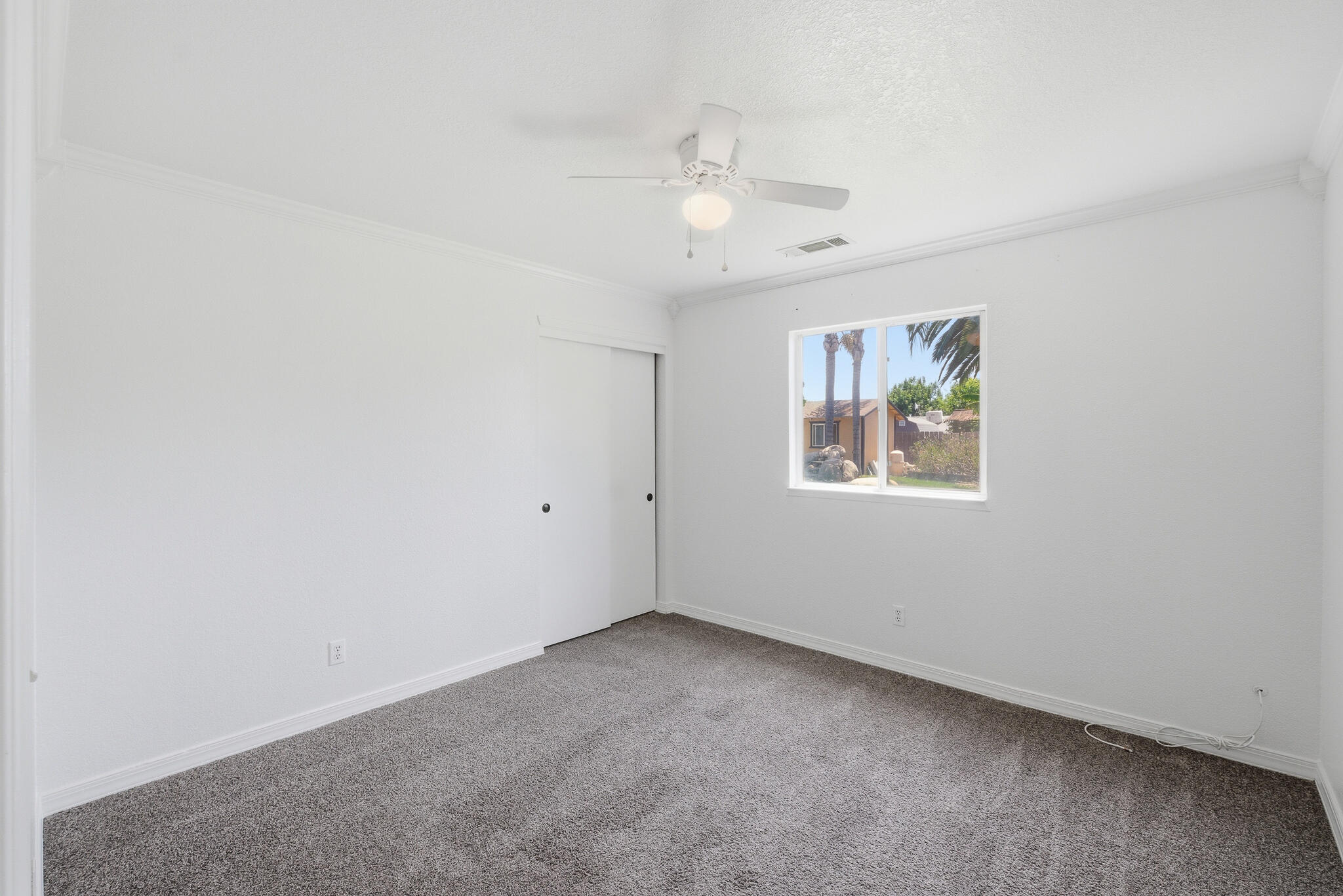 618 Birdsong Court Exeter, CA 93221 - Photo 26 of 62 an empty room with a window and ceiling fan