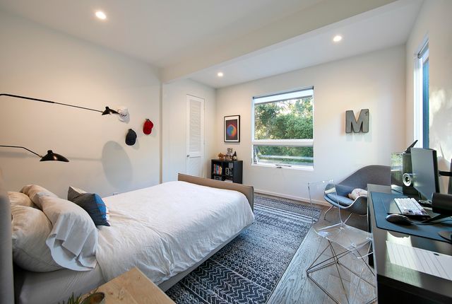 a bedroom with a bed and wooden floor