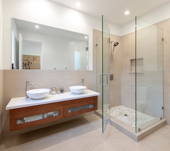 a bathroom with a double vanity sink mirror and shower