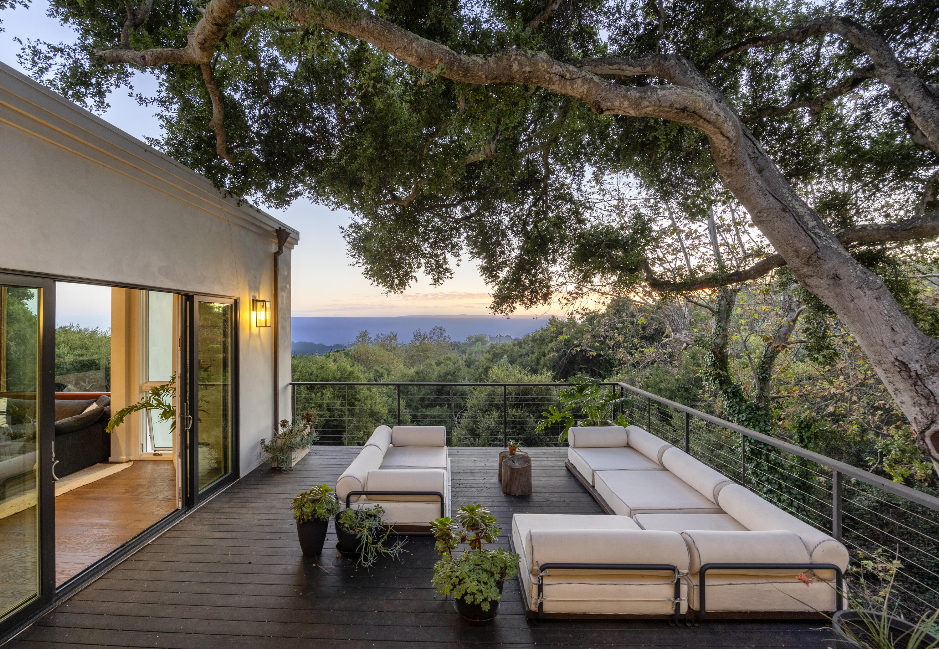 975 Mariposa Lane Montecito, CA 93108 - Photo 16 of 19 a view of a patio with couches table and chairs with wooden floor and fence