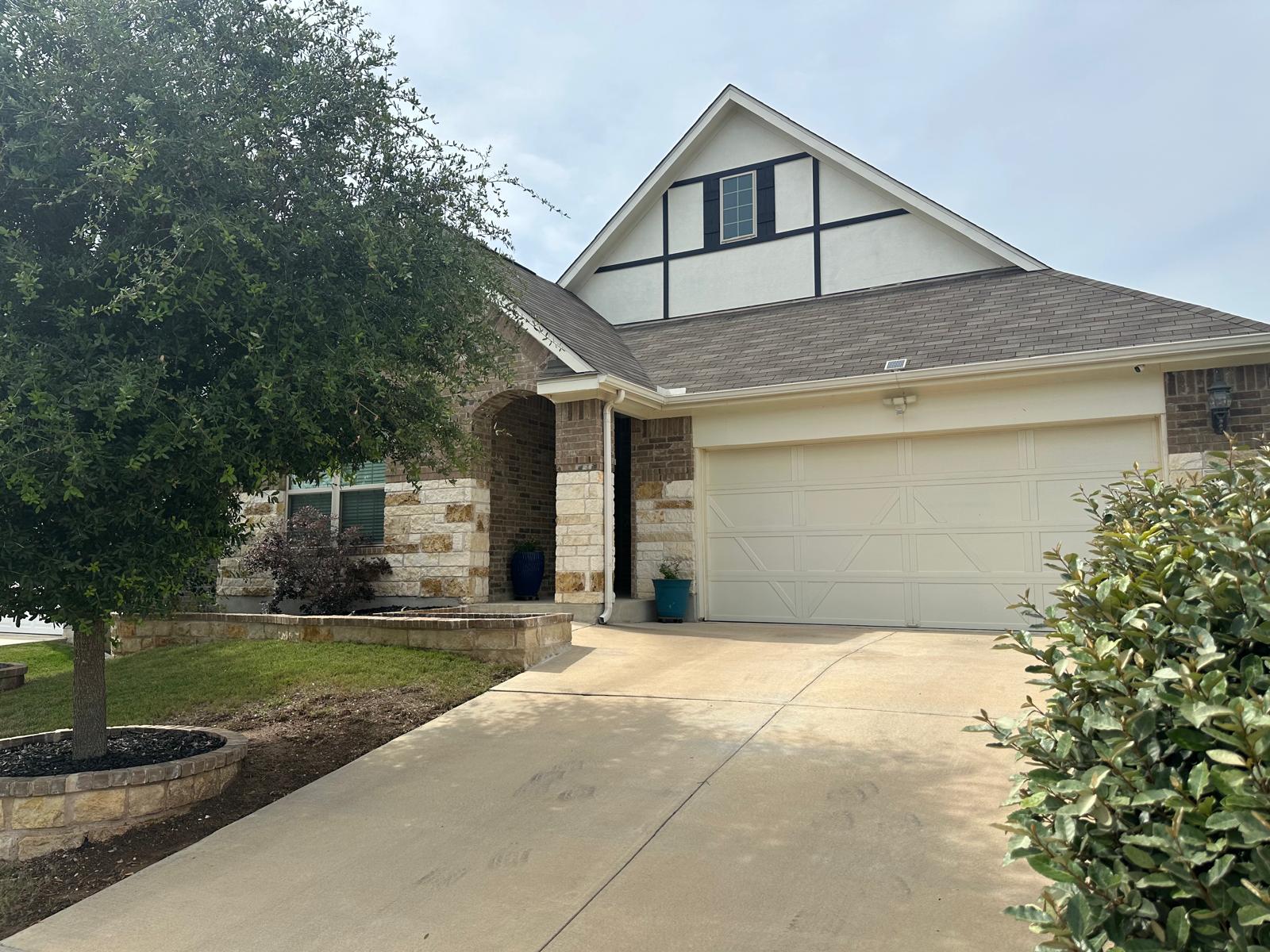 862 Leadtree Loop Buda, TX 78610 - Photo 2 of 40 a front view of a house with a yard and garage