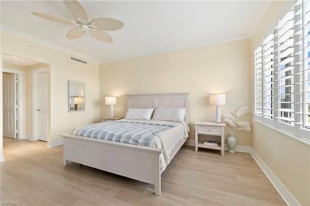 a spacious bedroom with a bed and a chandelier