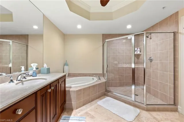 a bathroom with a tub a sink and glass door