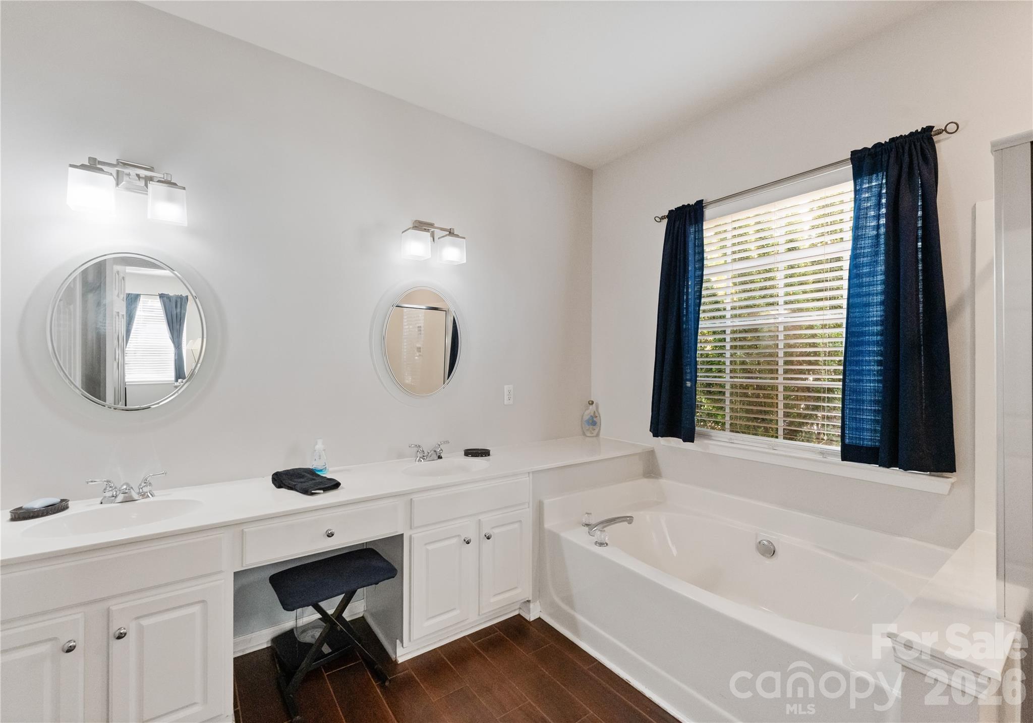20127 Beard Street Cornelius, NC 28031 - Photo 16 of 41 a bathroom with a tub double sink window and mirror