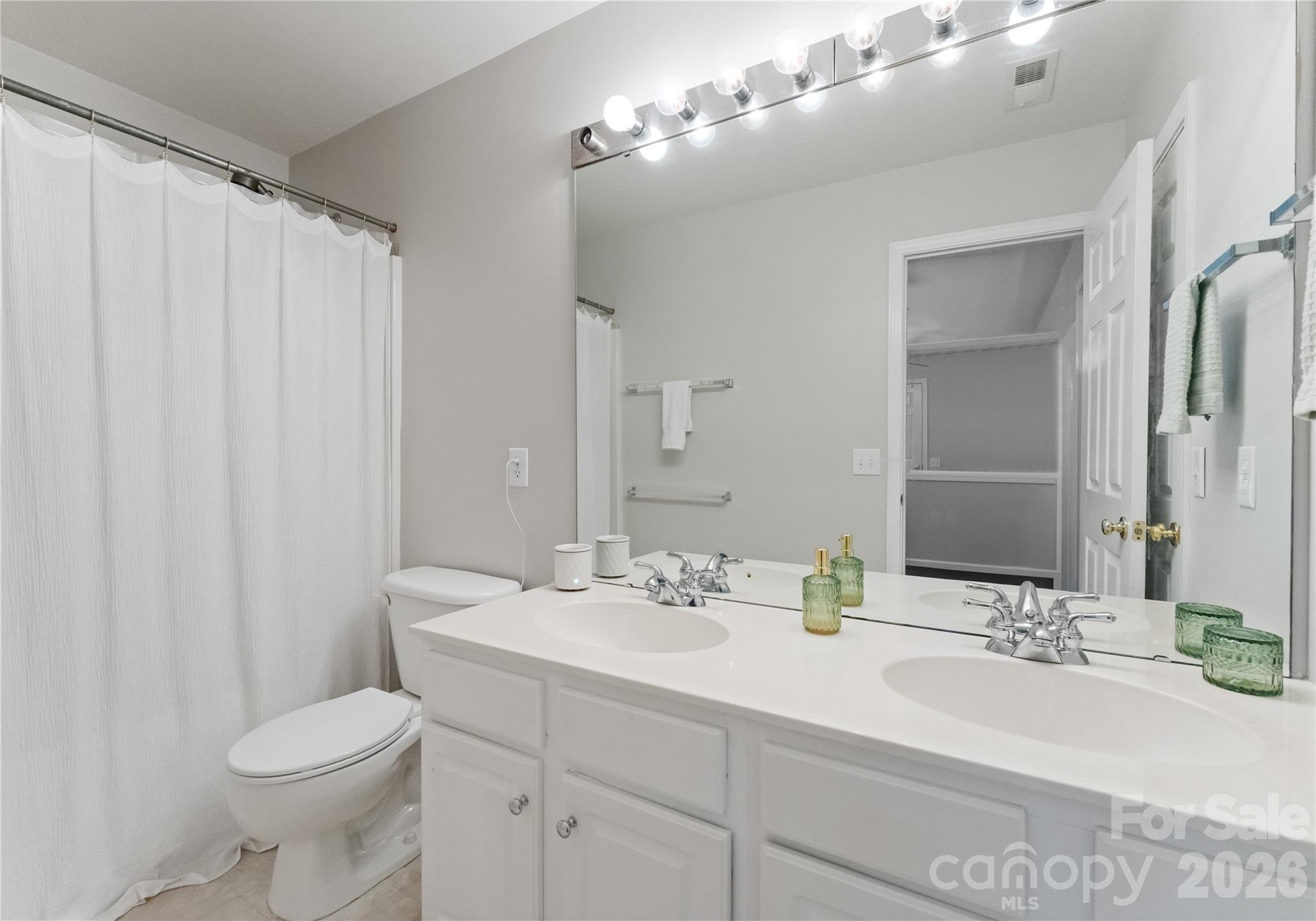 20127 Beard Street Cornelius, NC 28031 - Photo 21 of 41 a bathroom with a double vanity sink mirror and toilet