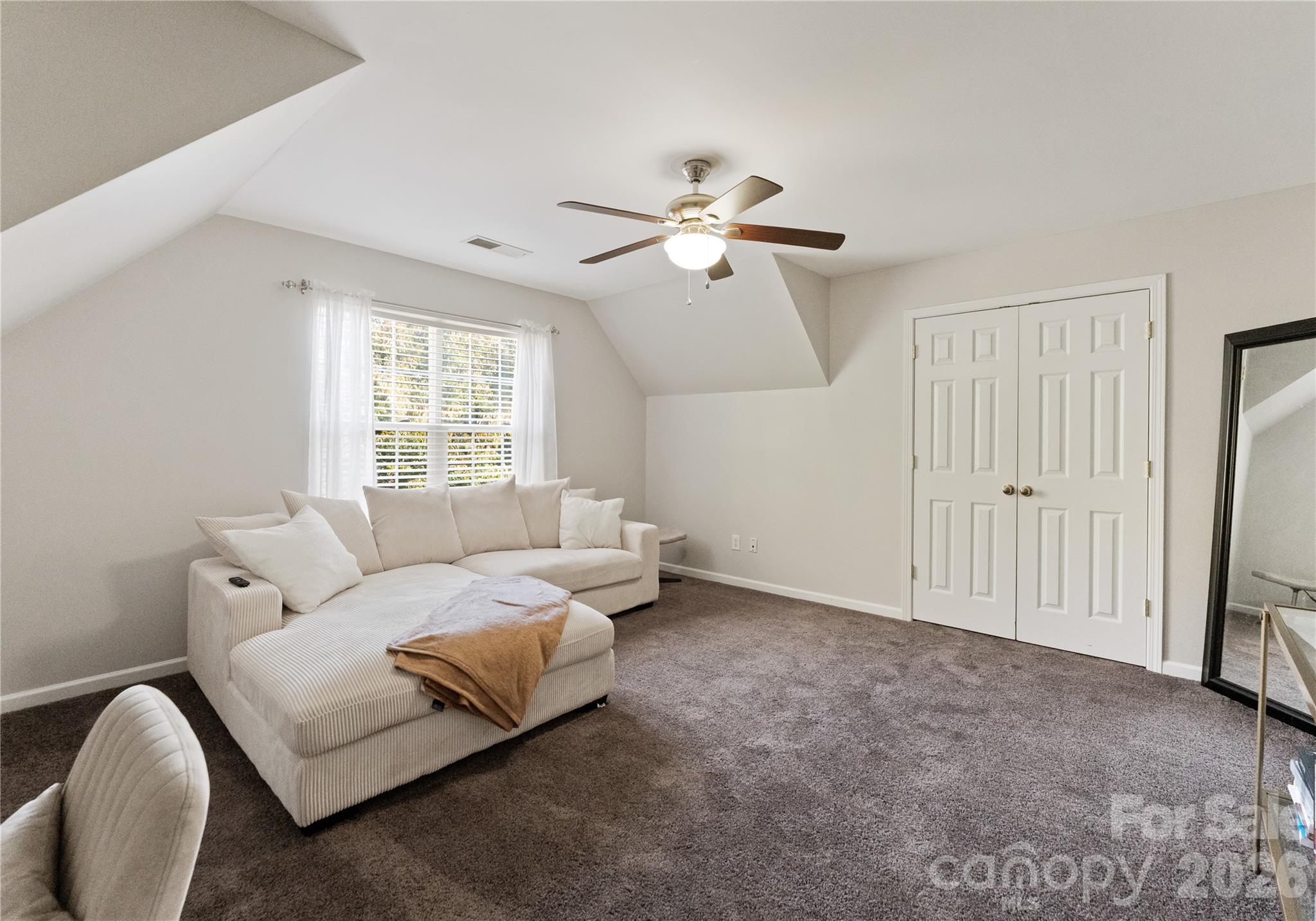 20127 Beard Street Cornelius, NC 28031 - Photo 23 of 41 a bedroom with bed and a chandelier