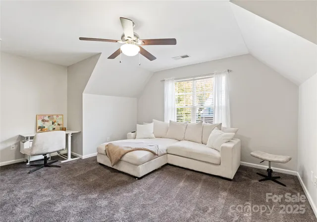 a living room with a bed furniture and a window