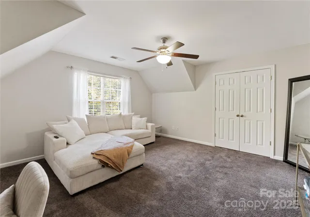 a bedroom with bed and a chandelier