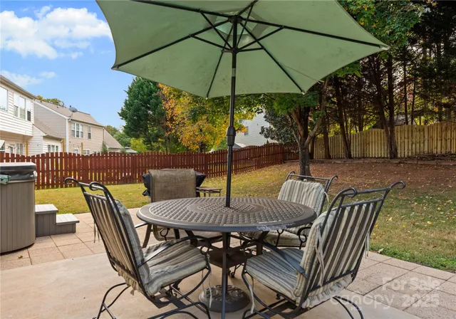 a view of an outdoor sitting area with furniture and umbrella