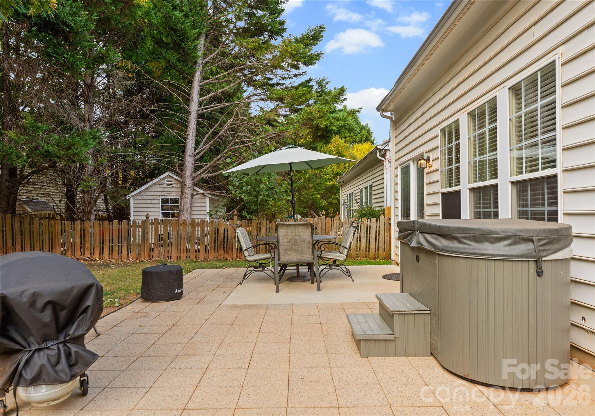 20127 Beard Street Cornelius, NC 28031 - Photo 29 of 41 a view of a patio with table and chairs under an umbrella