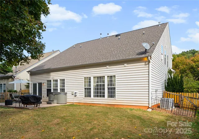 a backyard of a house with table and chairs