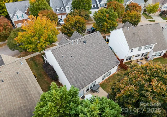 an aerial view of a house with a yard and garden