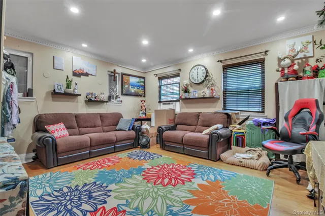 a living room with furniture a rug and flowers