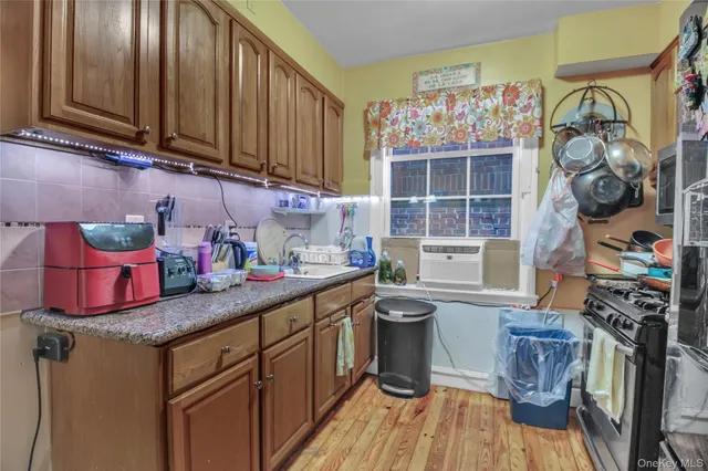 a kitchen with a sink cabinets and window
