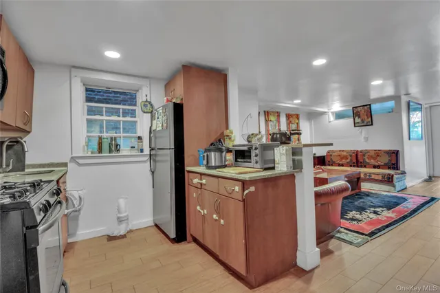 a kitchen with stainless steel appliances granite countertop a refrigerator and a stove