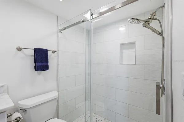 a bathroom with a shower a toilet and sink