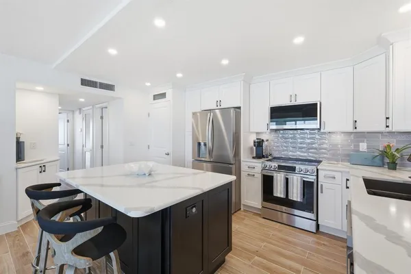 a kitchen with a stove a refrigerator and a sink