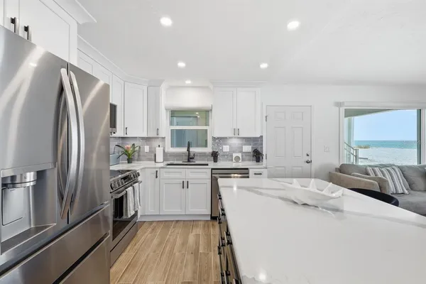 a kitchen with stainless steel appliances a refrigerator sink and stove
