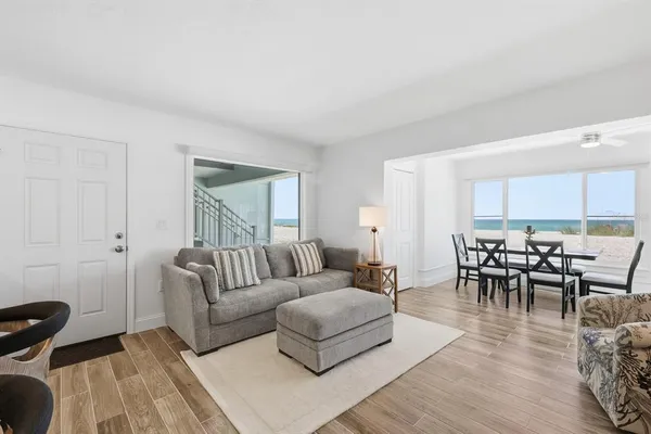 a living room with furniture wooden floor and a window