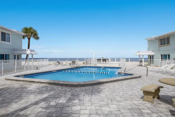 a view of a swimming pool with outdoor seating