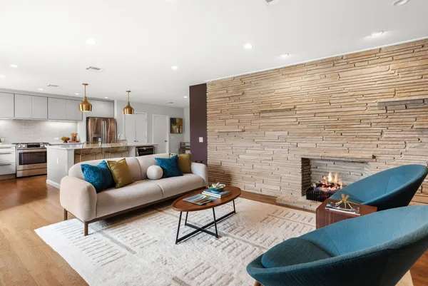 a living room with furniture and a fireplace