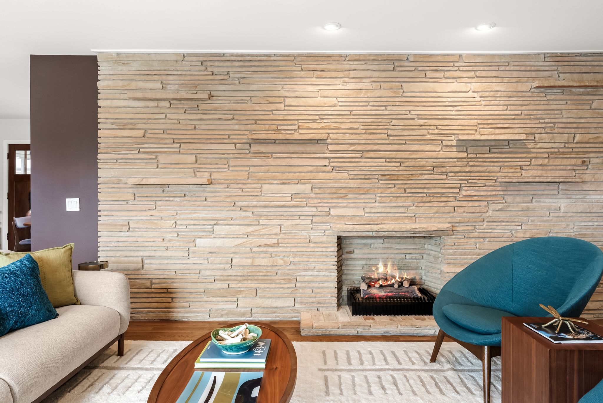 1612 Meadow Lane Taylor, TX 76574 - Photo 5 of 36 A gorgeous stacked stone wall sits at the center of the home flanking both living rooms.