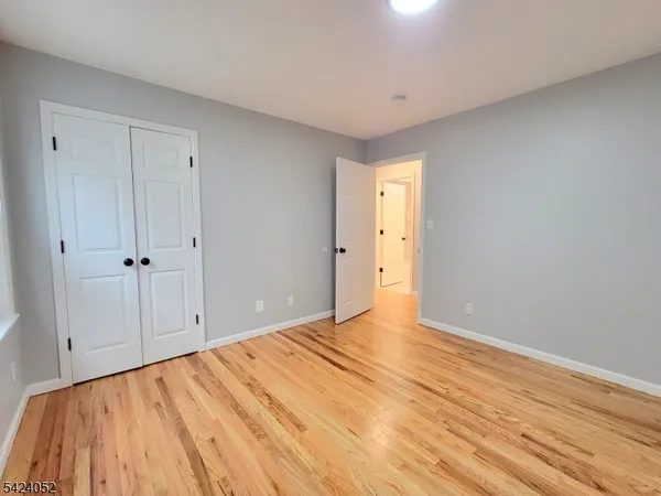 a view of an empty room and wooden floor
