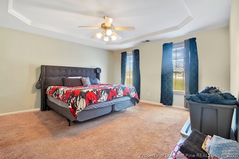 10 Pender Road Spring Lake, NC 28390 - Photo 21 of 35 a bedroom with a bed and a chandelier