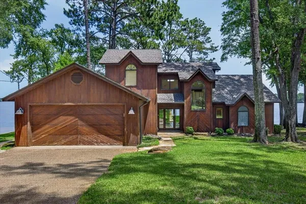 a front view of house with yard and green space