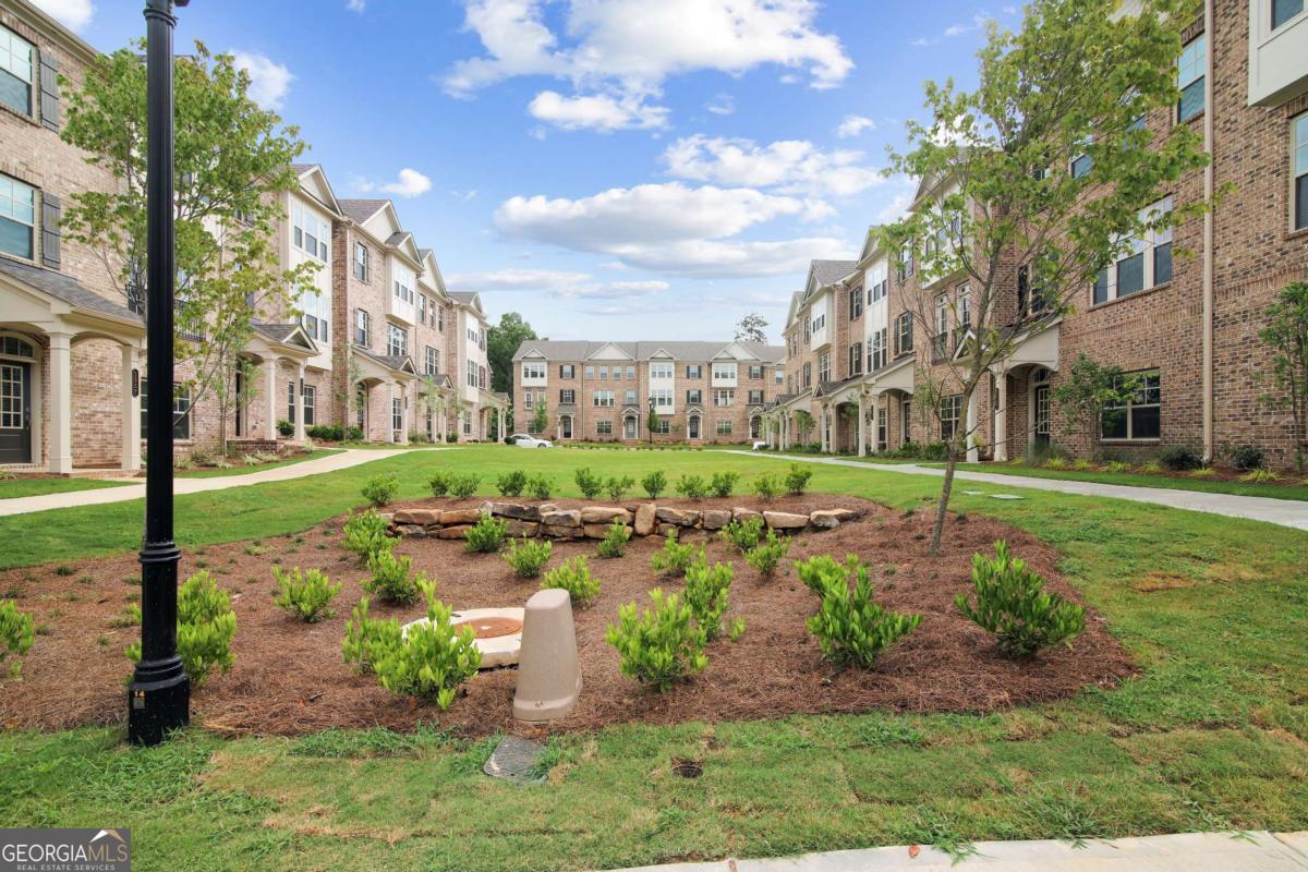 1526 Halstead Place, Unit 1526 Suwanee, GA 30024 - Photo 23 of 24 a view of a garden with a fountain
