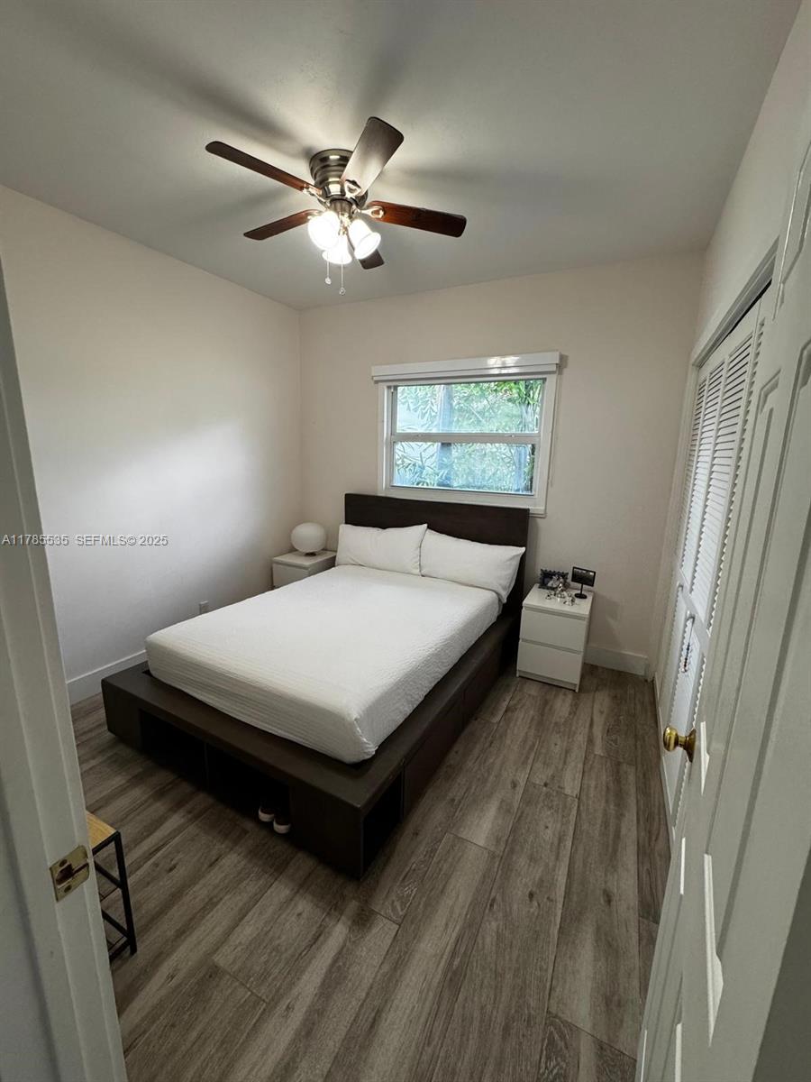 101 Southwest 101st Terrace, Unit 101 Plantation, FL 33324 - Photo 11 of 15 a bedroom with a bed and a chandelier