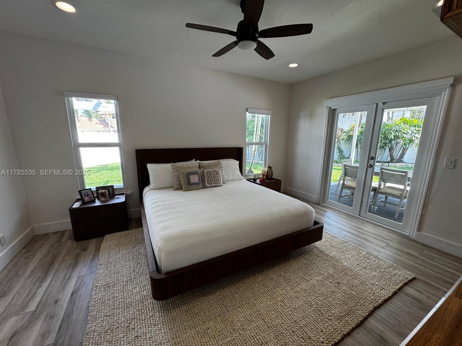 101 Southwest 101st Terrace, Unit 101 Plantation, FL 33324 - Photo 8 of 15 a bedroom with a bed and a large window