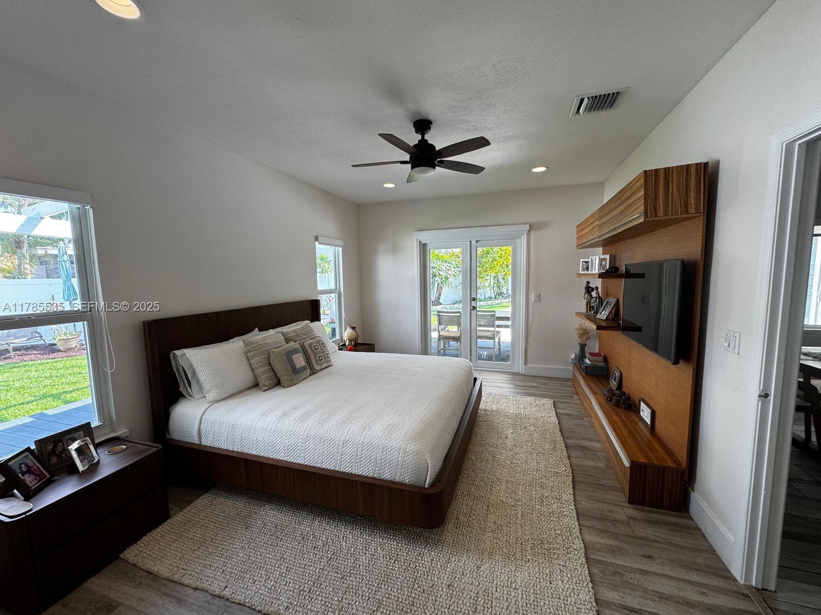 101 Southwest 101st Terrace, Unit 101 Plantation, FL 33324 - Photo 9 of 15 a bedroom with a bed a flat screen tv and a window