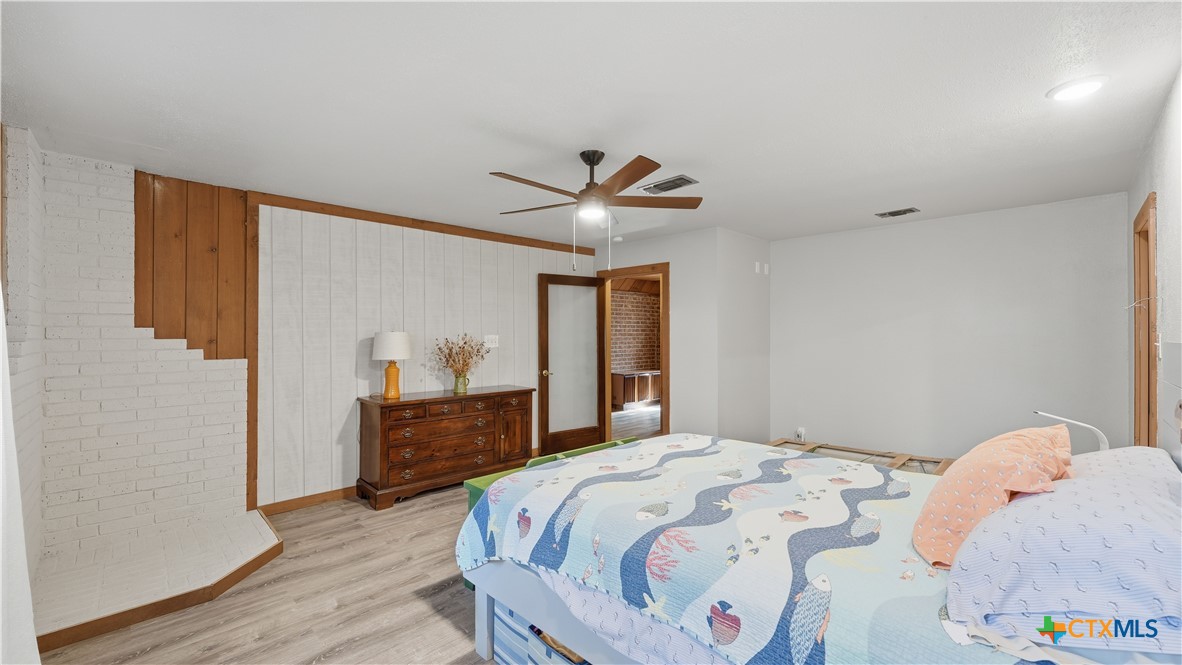 3781 Ridgeway Drive San Antonio, TX 78259 - Photo 19 of 44 a bedroom with a bed and a chandelier