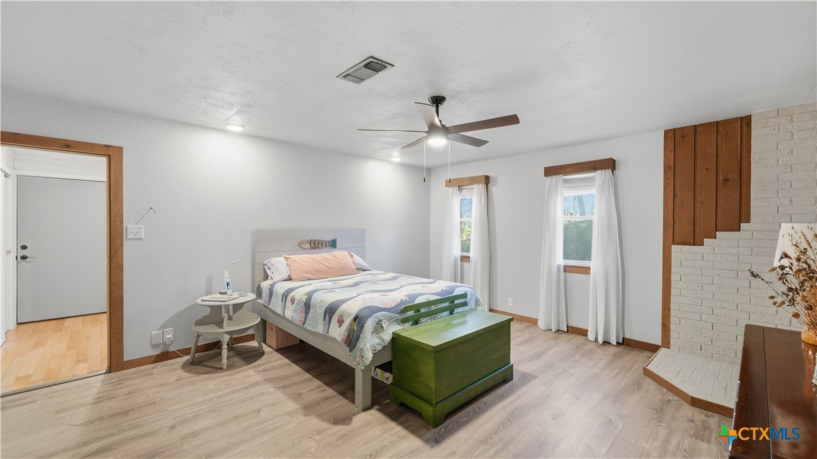 3781 Ridgeway Drive San Antonio, TX 78259 - Photo 21 of 44 a bedroom with a bed and a chandelier