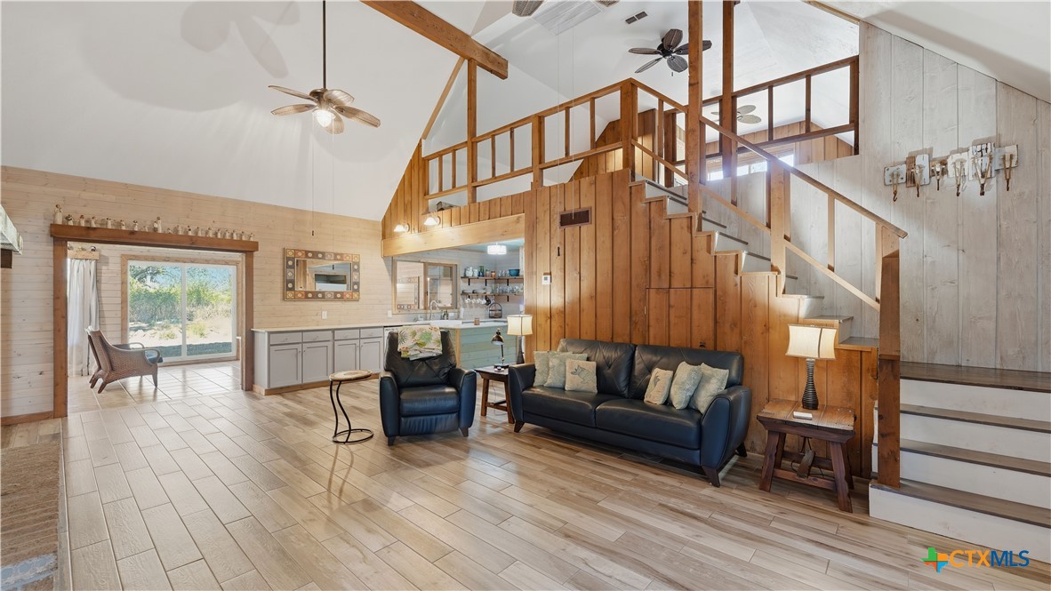 3781 Ridgeway Drive San Antonio, TX 78259 - Photo 44 of 44 a living room with couches and a dining table with wooden floor
