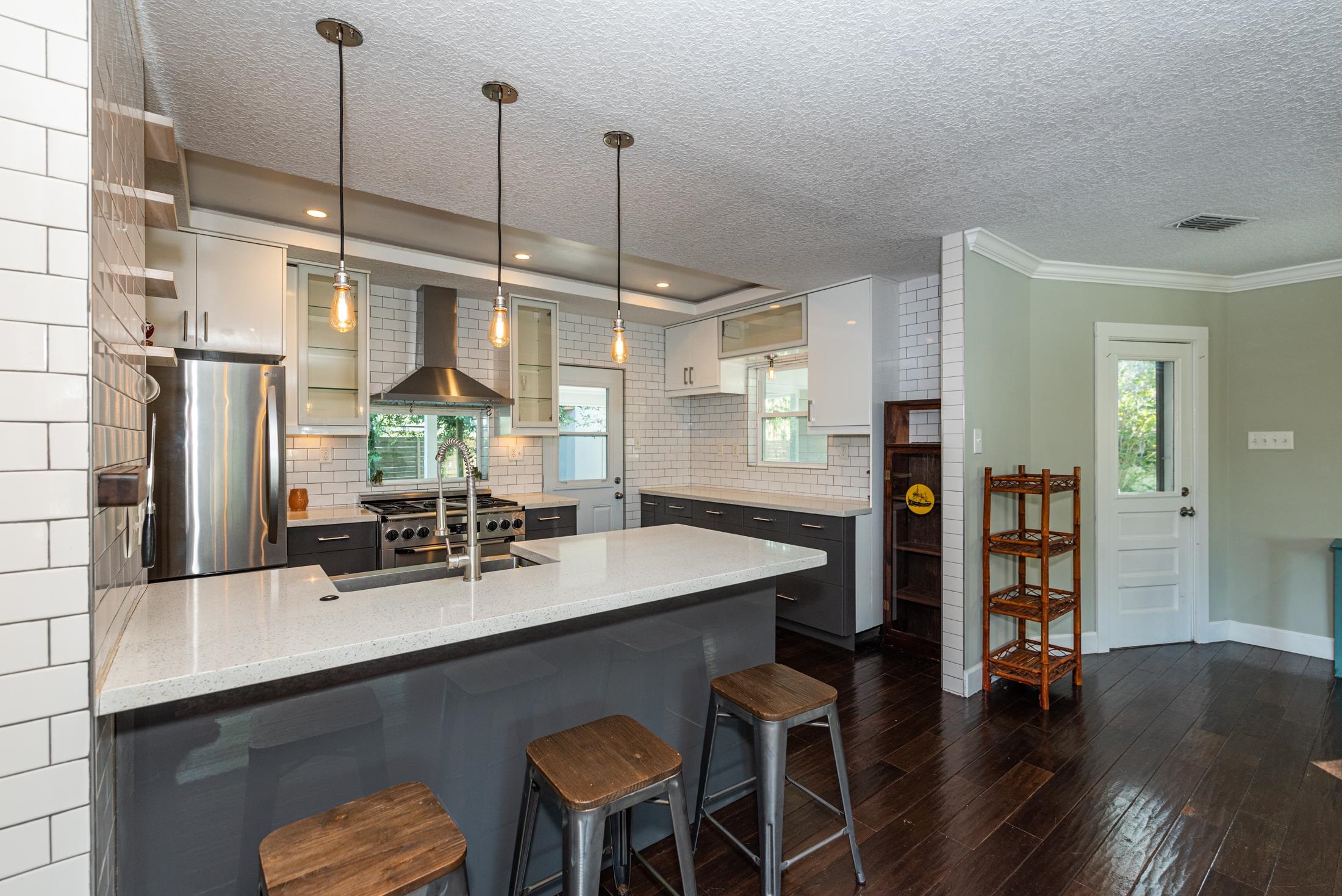 134 Neptune Road St. Augustine, FL 32086 - Photo 11 of 36 a kitchen with stainless steel appliances granite countertop a sink a stove a dining table and chairs