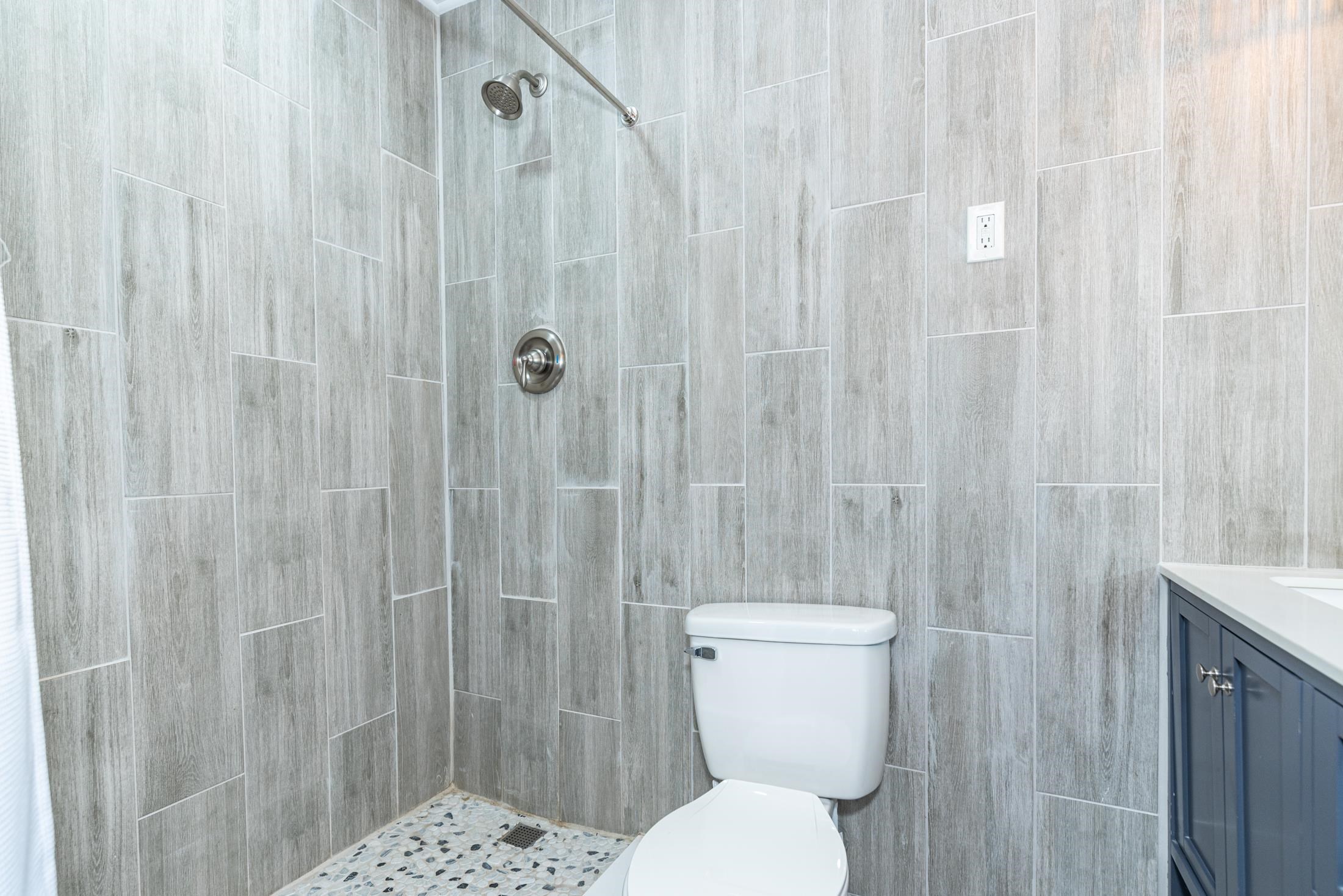 134 Neptune Road St. Augustine, FL 32086 - Photo 19 of 36 a white toilet sitting next to a shower curtain