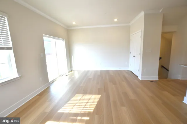 a view of a room with wooden floor and a window