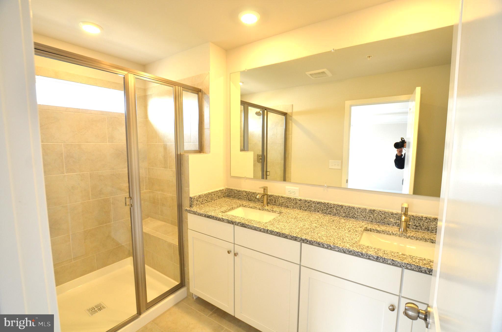 1832 Parham Way Baltimore, MD 21244 - Photo 13 of 25 a bathroom with a granite countertop sink and a mirror