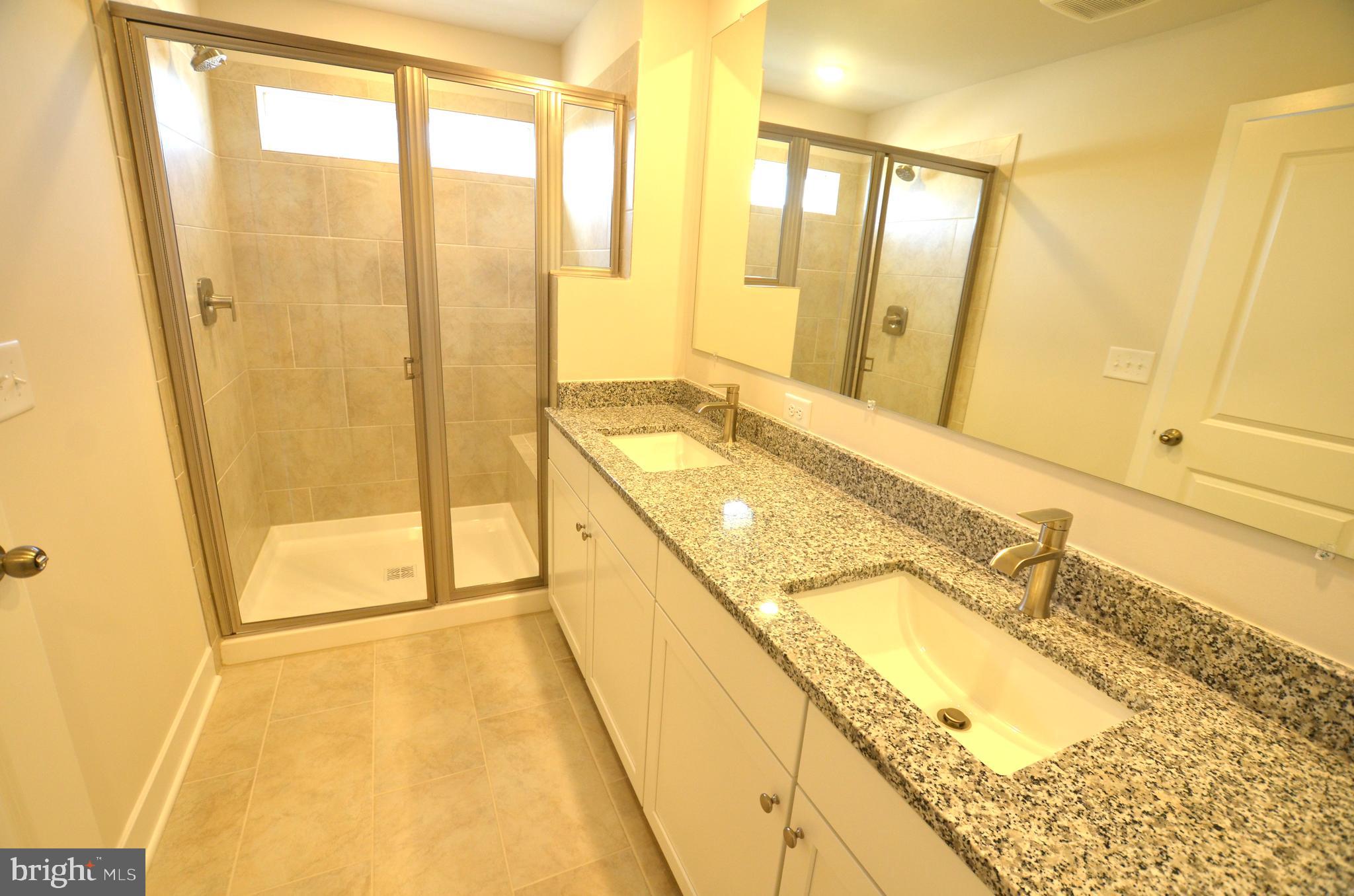 1832 Parham Way Baltimore, MD 21244 - Photo 15 of 25 a spacious bathroom with a granite countertop shower and a sink
