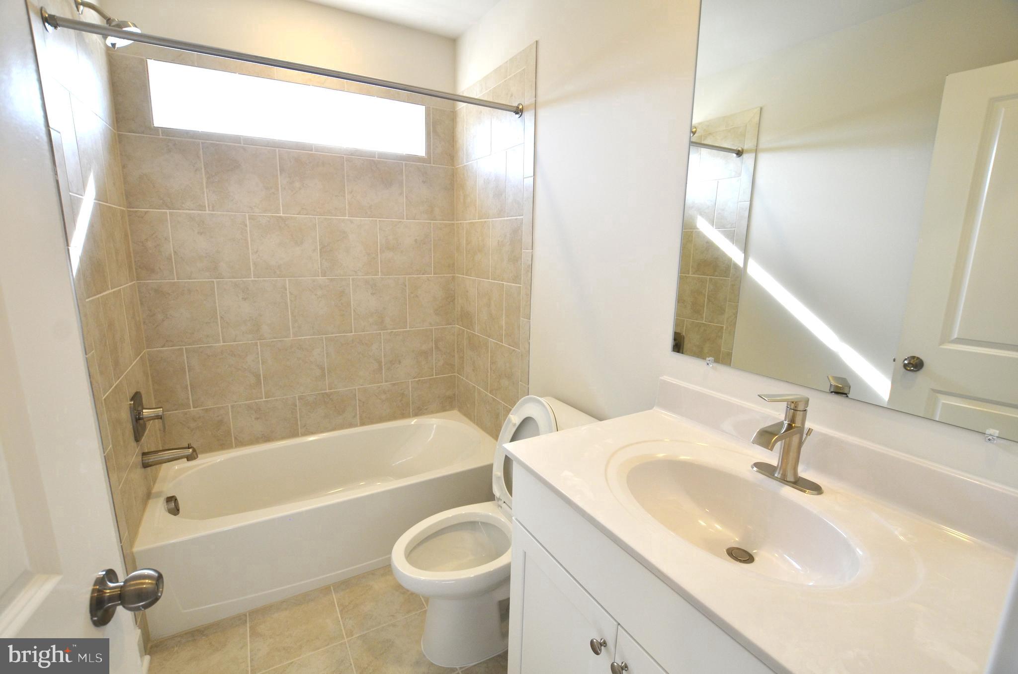 1832 Parham Way Baltimore, MD 21244 - Photo 18 of 25 a bathroom with a sink mirror toilet and bathtub
