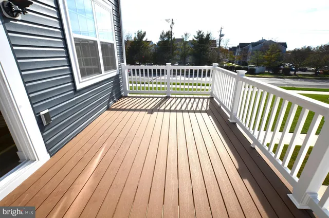 a view of balcony with wooden floor and fence