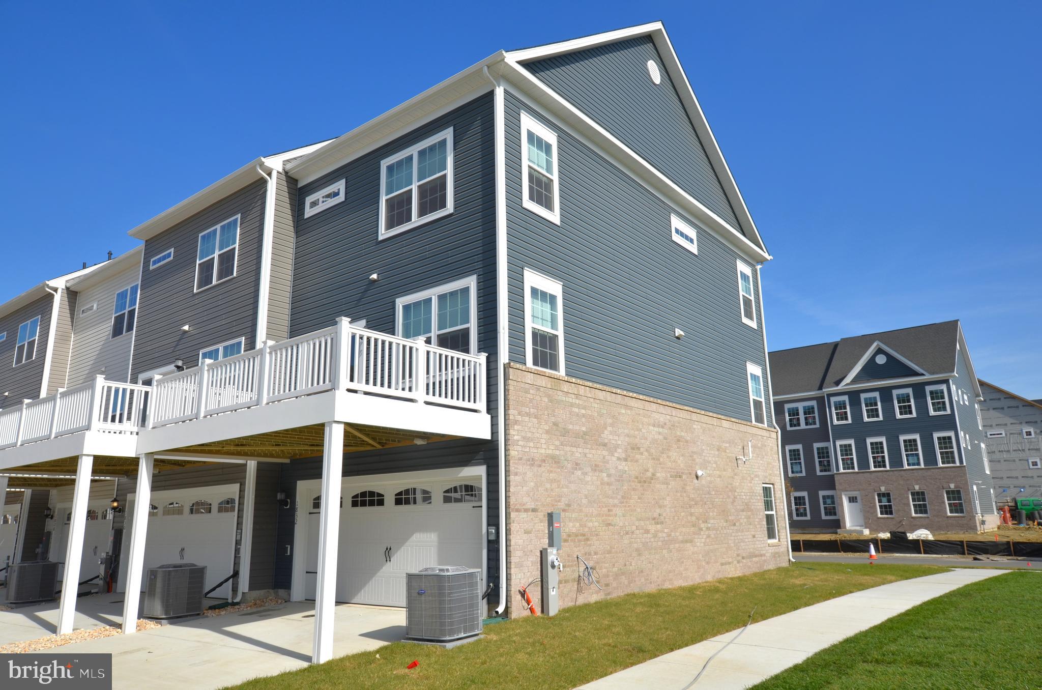1832 Parham Way Baltimore, MD 21244 - Photo 24 of 25 a front view of a building with a yard