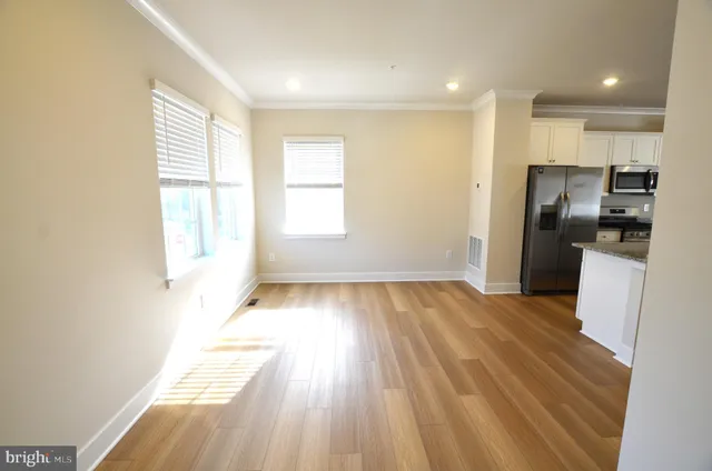 a view of a kitchen with a sink and refrigerator