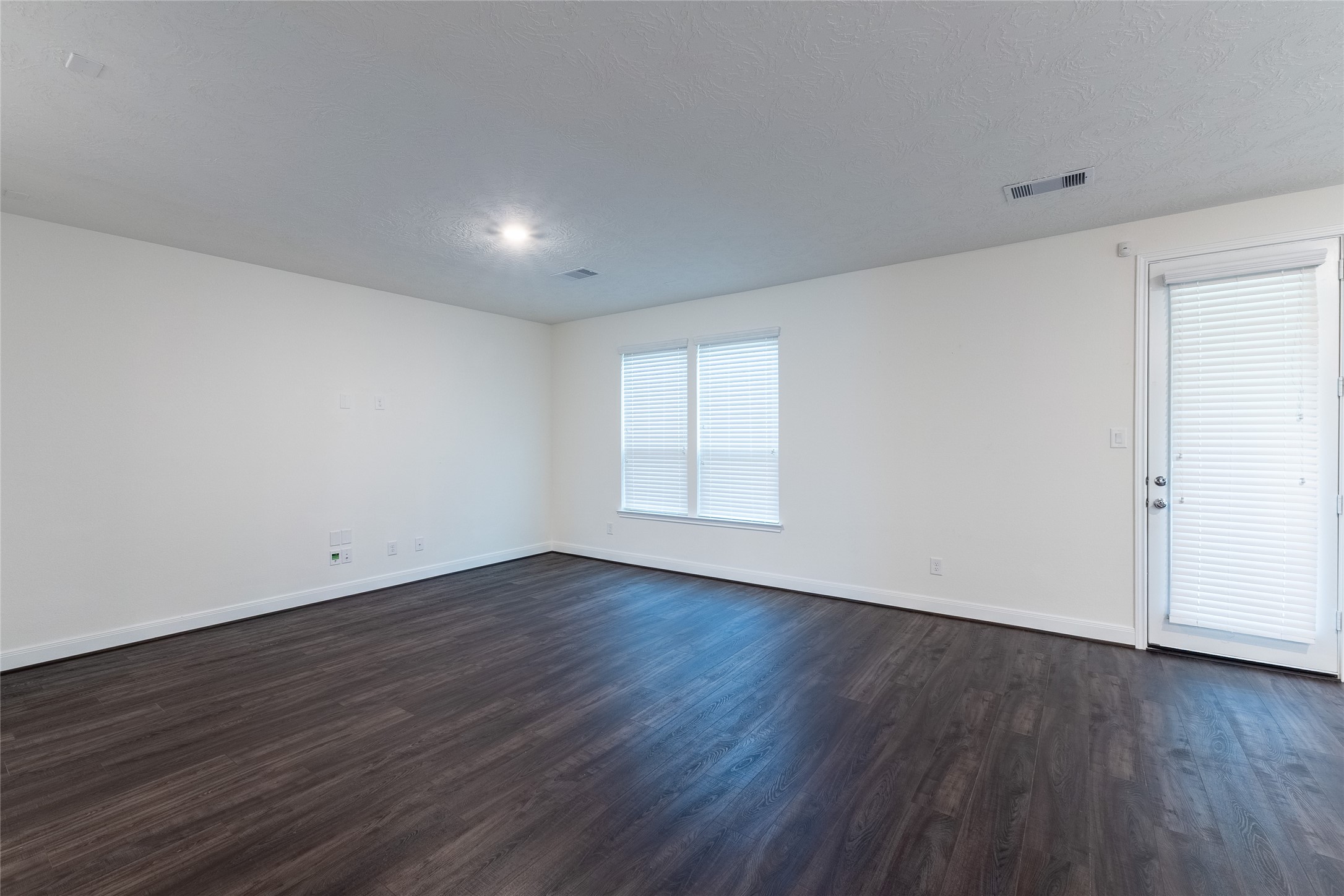 27646 Mesabe Drive Magnolia, TX 77354 - Photo 11 of 24 a view of an empty room with wooden floor and a window
