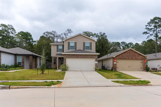 a front view of a house with a yard and outdoor seating